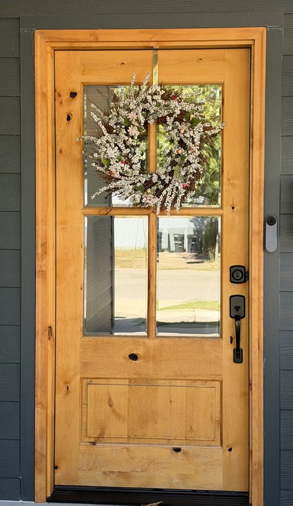 A wood front door with a fall wreath